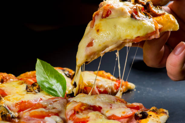 istock Slice of pizza. melted cheese stretches from the piece 1671506289