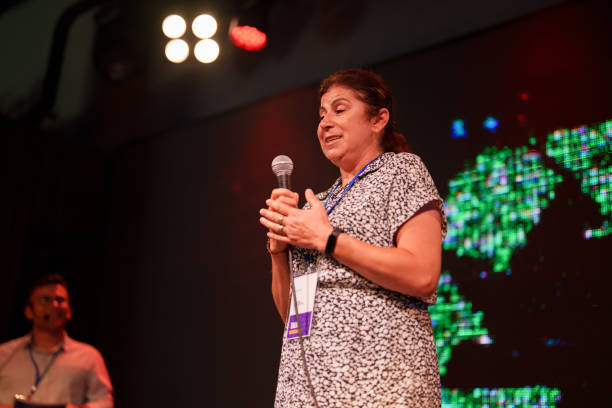 istock Mature Woman talking on stage about Ecology 1671531317