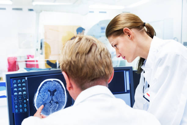istock Doctors Discussing MRI Scan on Monitor 167154497