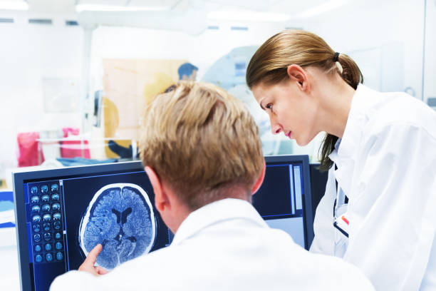 Doctors Discussing MRI Scan on Monitor stock photo