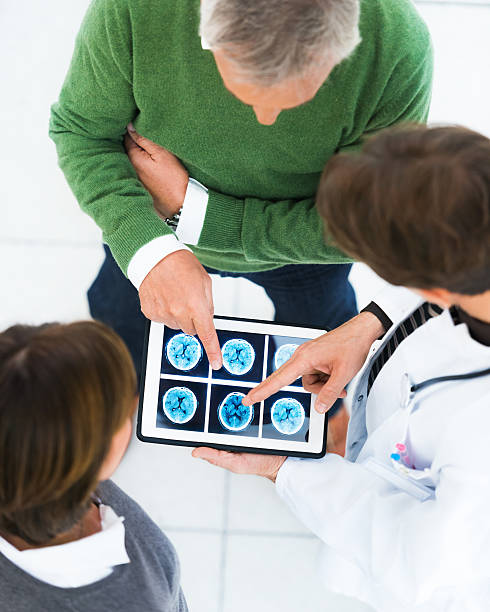 istock Patients and Doctor Discussing CAT-Scan on Tablet PC 167154498