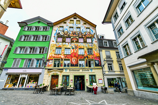 Lucern- May 17 ,2023 : Colorful Historical buildings with frescos at picturesque square Muhlenplatz ,Switzerland.