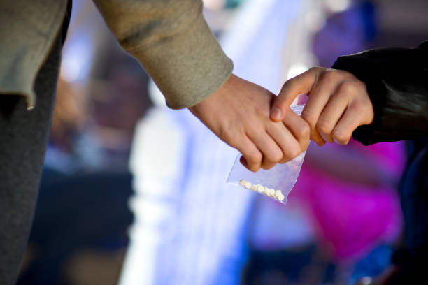 ecstasy at a house party ecstasy being handed over at a house party.. recreational drug stock pictures, royalty-free photos & images