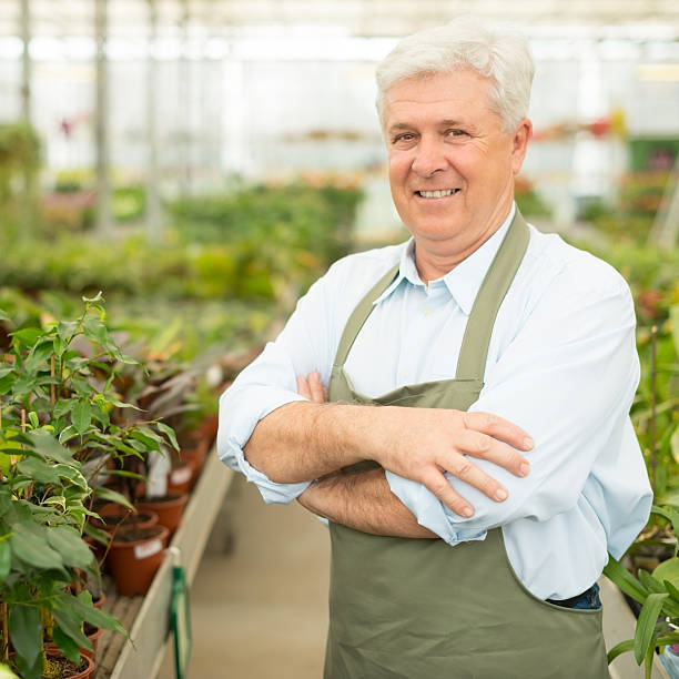 istock Senior florist posing in greenhouse 167156746