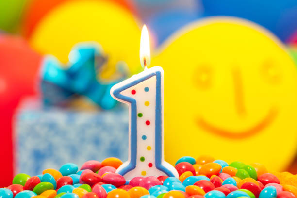 Cake for first birthday,balloons and gift box background.