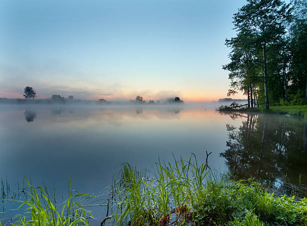istock Foggy sunrise on a lake 167160096