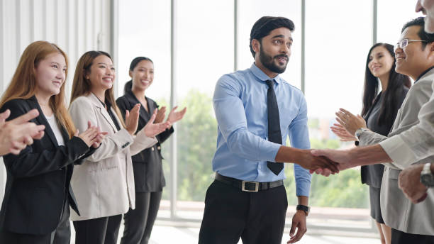 istock Successful business team is clapping. Happy business people clapping hands. Company workers applauding colleagues in corporate meeting 1671610324