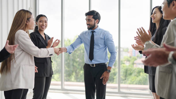 istock Successful business team is clapping. Happy business people clapping hands. Company workers applauding colleagues in corporate meeting 1671610329