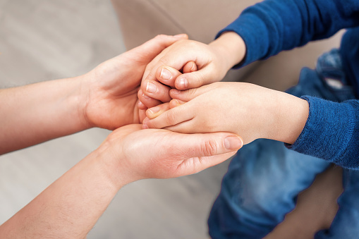 Love, support and mother holding hands with child for trust, safety and hope for foster care or adoption.Family connect in hope, advice and peace while bonding