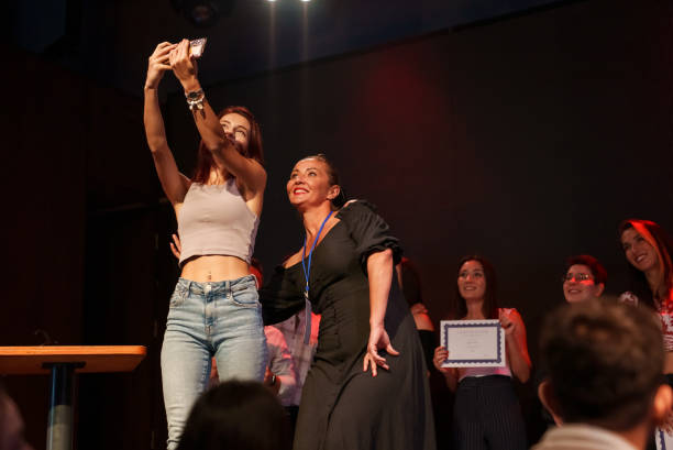 istock People taking selfies at Certificate Ceremony on Stage 1671628422