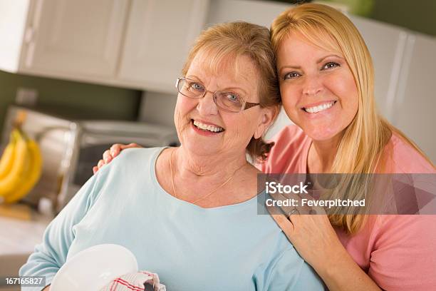Senior Adult Woman And Young Daughter Portrait In Kitchen Stock Photo - Download Image Now
