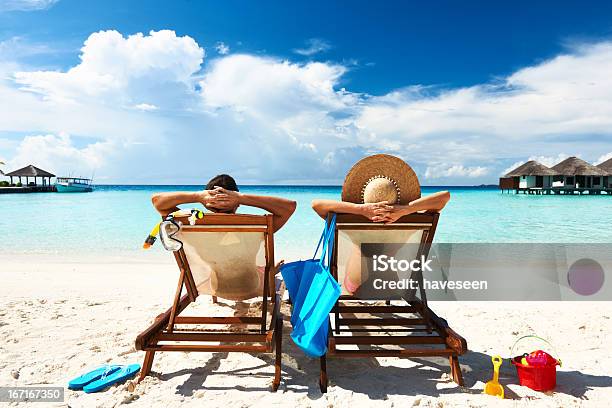 Couple On A Beach Stock Photo - Download Image Now - Beach Holiday, Couple - Relationship, Beach