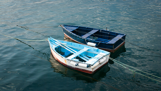 Two boats tied in a marina