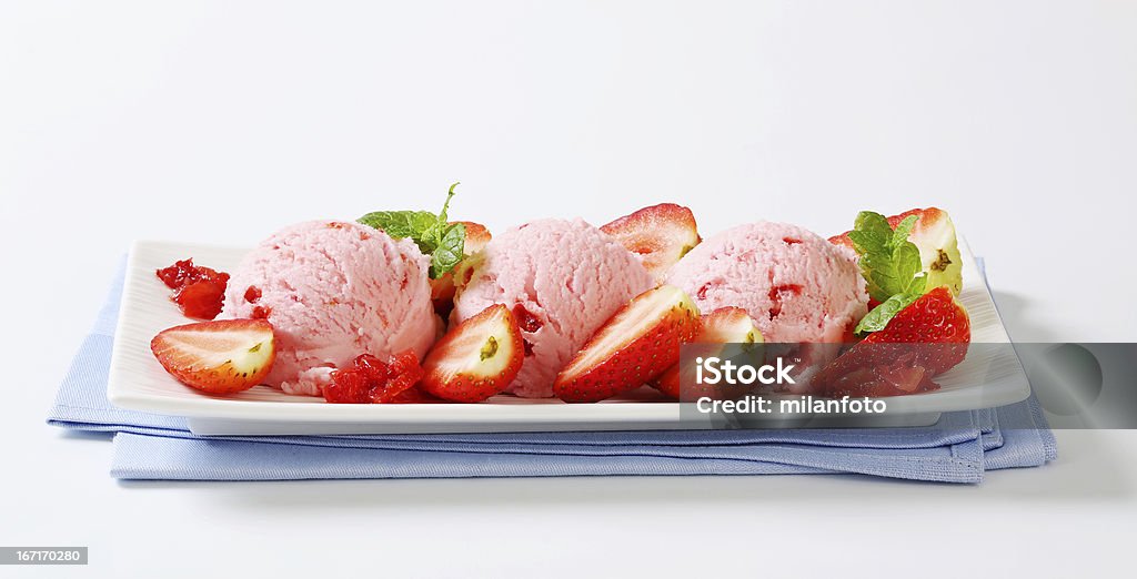 Three scoops of strawberry ice cream Three scoops of strawberry ice cream with raw fruits on a tray Ice Cream Stock Photo