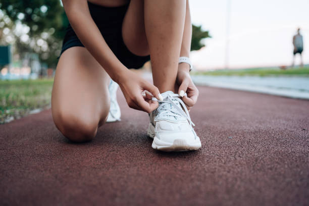 istock Woman tying running shoes 1671707460
