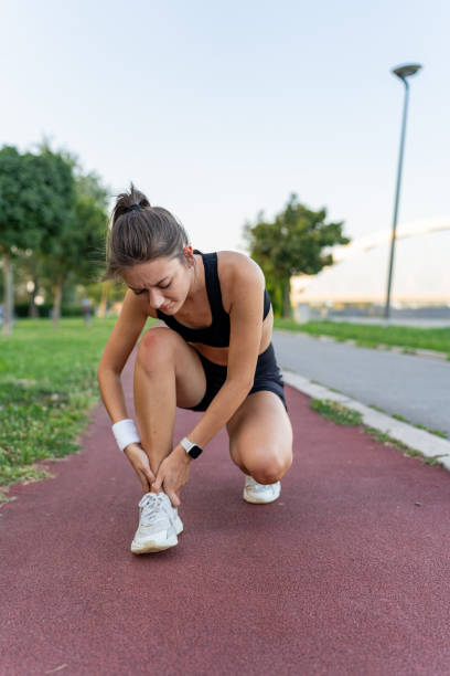 istock Young female jogger checking her hurt ankle 1671708588