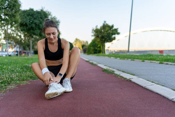 istock Young female jogger with an ankle injury 1671708589