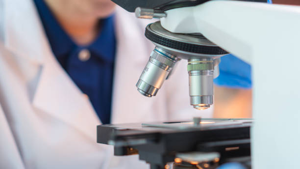istock Close up scientist wearing glassware working with microscope for research and analysis experiment medical biotechnology medicine pharmaceutical healthcare 1671721465