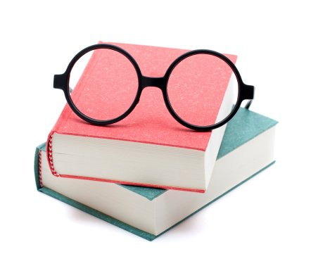 Books and glasses isolated on white background