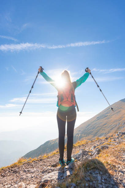 istock Happy young hiker woman with raised arms 1671725630