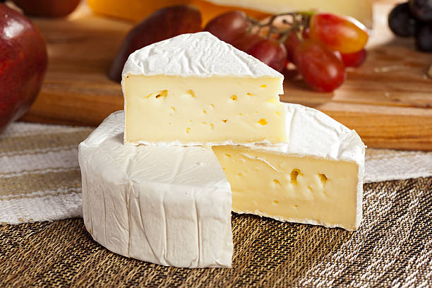 Fresh Organic White Brie Cheese Fresh Organic White Brie Cheese on a background brie stock pictures, royalty-free photos & images