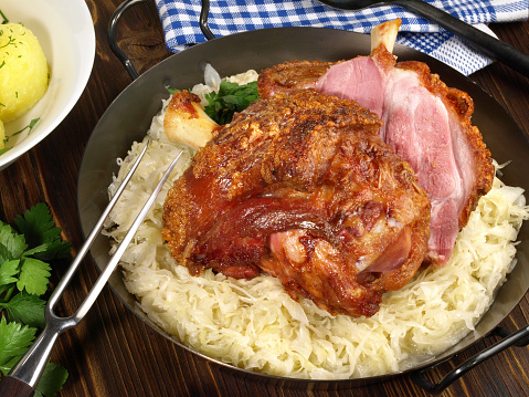 Grilled crusty Pork Knuckle with Sauerkraut in a Pan