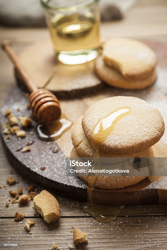 Sandy Cookies A stack of homemade sandy cookies topped with sugar. A bowl with some honey is in the background. Baked Stock Photo