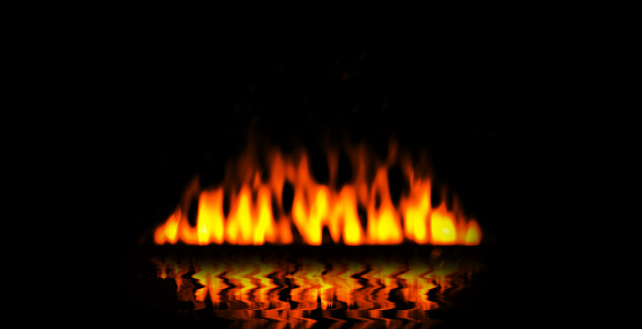 Fire flames on black background with reflection in water