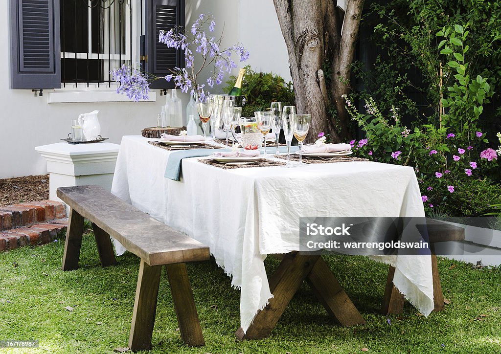 Farmstyle rustic table setting Table setting for an casual outdoor garden party with neutral nude color scheme Tablecloth Stock Photo