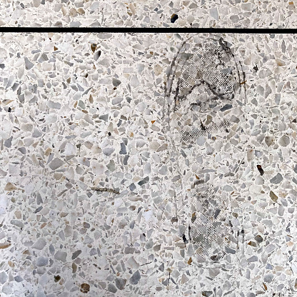 Shoe mark on granite floor at the entrance of a residential building of Caracas city
