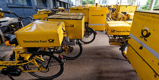 german post bicycles - deutsche post ag package germany occupation imagens e fotografias de stock