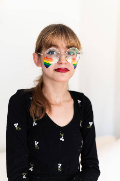 istock Girl with a rainbow heart shape painted on face 1671836378