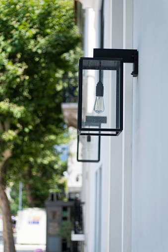 Modern squared black outdoor lamp in a modern street in Athens
