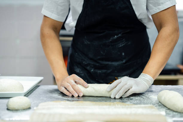 istock Close-up of baker making bread in his bakery 1671858603