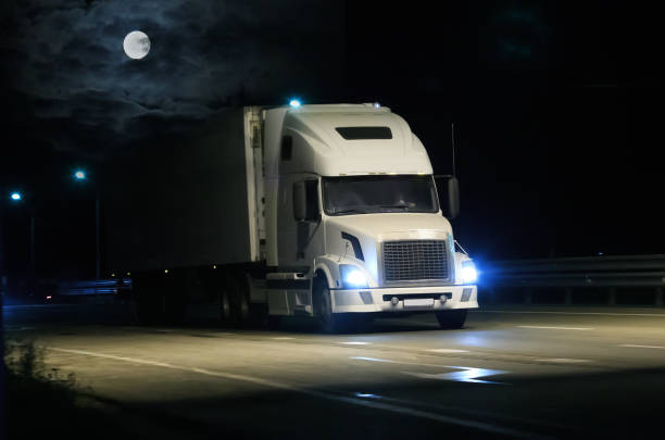 istock Large Truck drives along a suburban highway 1671859189