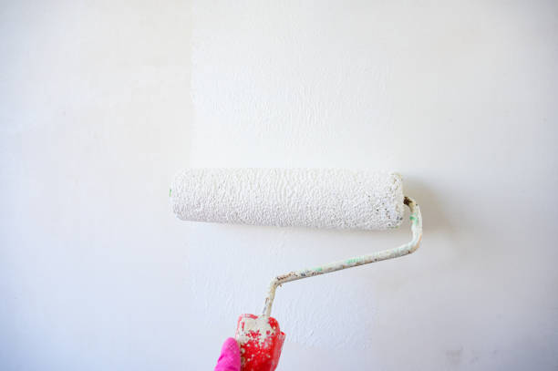 istock Painting interior wall with paint roller brush. 1671864250