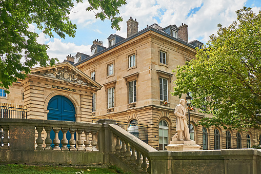 Paris, France - July 11, 2023: Statue of Claude Bernard in front of the College de France.