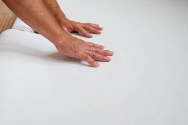 istock Worker are preparing wallpaper for hanging. 1671915660