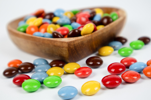 pile of colorful chocolate candies on white background