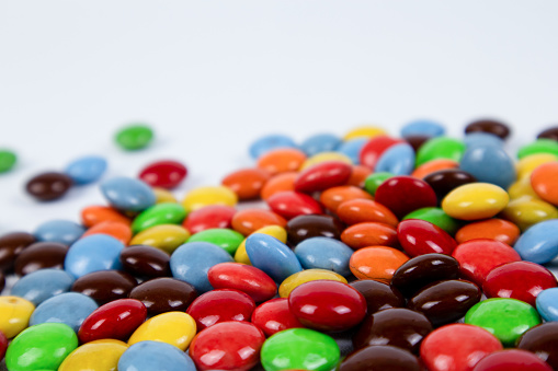 pile of colorful chocolate candies on white background