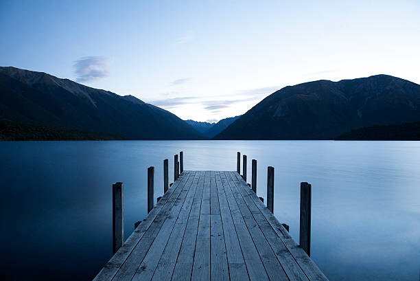 Evening on Lake Rotoiti, Nelson Lakes National Park, NZ Evening on Lake Rotoiti, Nelson Lakes National Park, South Island, New Zealand. Long exposure if the jetty in to the lake. dusk long exposure nelson rotoiti south island stock pictures, royalty-free photos & images