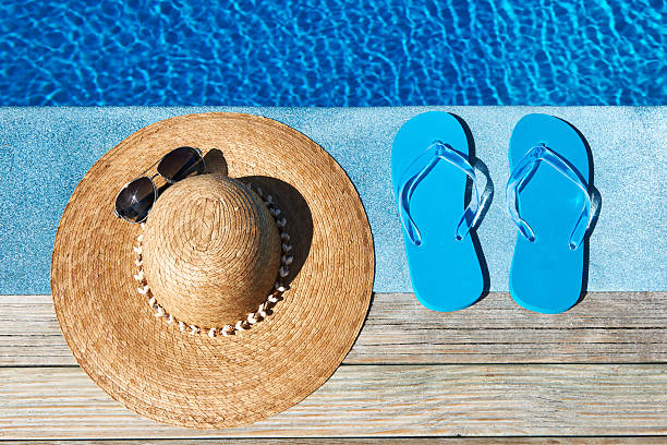 istock Blue slippers and hat by a swimming pool 167195694