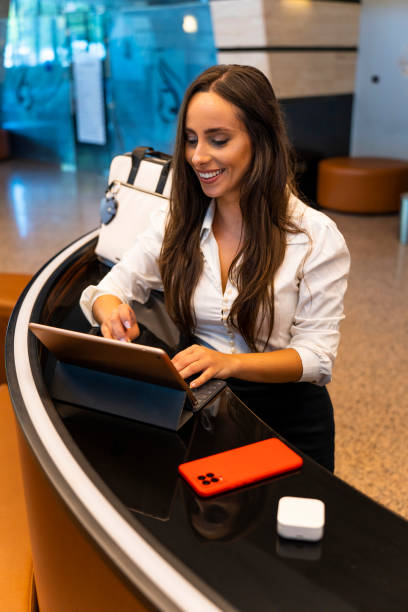 istock Smiling cheerful hotel receptionist checks your details 1671962312