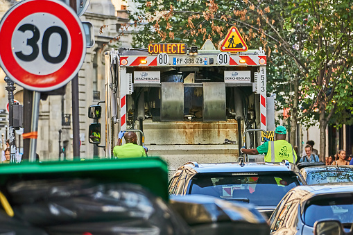 Paris, France - July 11, 2023: Garbage collectors are blocking traffic on the streets of Paris.