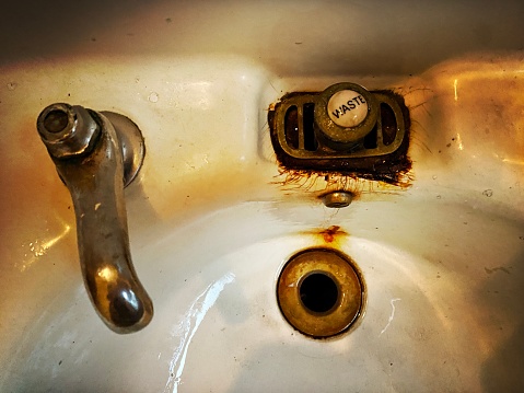 Dirty wash basin with mold around.