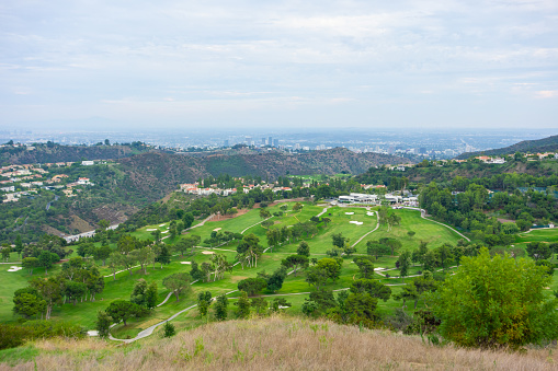 Views of the Mountain Gate Country Club in Brentwood with views of the  Los Angeles cityscape in the background.