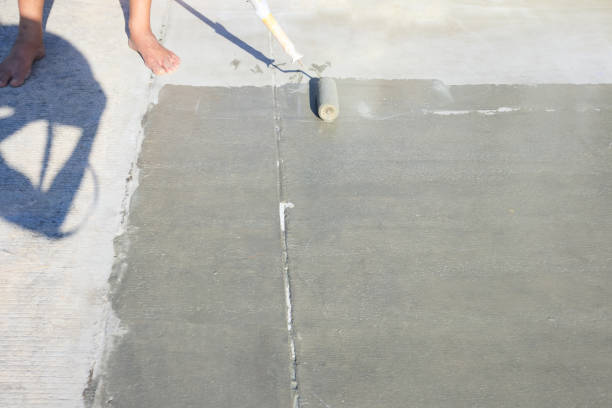 istock Worker to skim coat surface of concrete pavement floor or slab. 1671996889