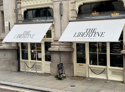 London, UK - August 24, 2023: The Libertine, a bar and restaurant located in the vaults under the historic Royal Exchange building in the City of London, UK.