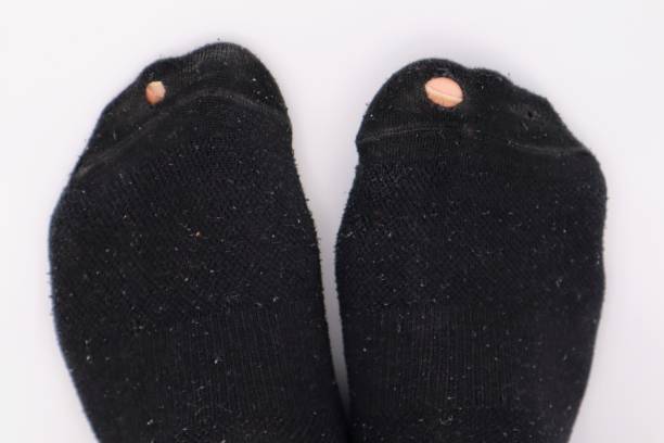 istock Close-up of socks with holes 1672008683