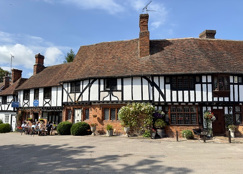 Chilham, UK - August 17, 2023: Historic residential houses dating from the 15th century and a tea shop in the village of Chilham, Kent, UK.